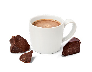 Eine Tasse Kakao mit Kakao Brocken daneben